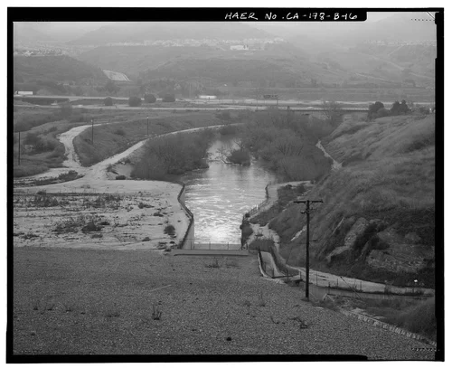  DOWNSTREAM VIEW OF OUTLET STRUCTURE AND OUTLET CHANNEL, FROM WEST END OF EMBANKMENT. - Prado Dam, Outlet Works, Santa Ana River near junction of State Highways 71 & 91, Corona, Riverside County, CA