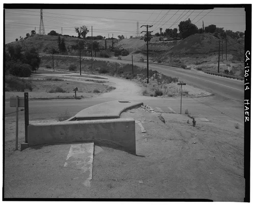  VIEW OF GAGE IRRIGATION CANAL AT HILLTOP DRIVE AND BARTON ROAD, SHOWING OLD ROUTE OF CANAL VIADUCT ACROSS BARTON ROAD. SIPHON NOW GOES UNDER ROAD AND EMERGES AT RIGHT REAR BELOW TWO TELEPHONE POLES (SEE CA-120-15) - Gage Irrigation Canal, Running from Santa Ana River to Arlington Heights, Riverside, Riverside County, CA