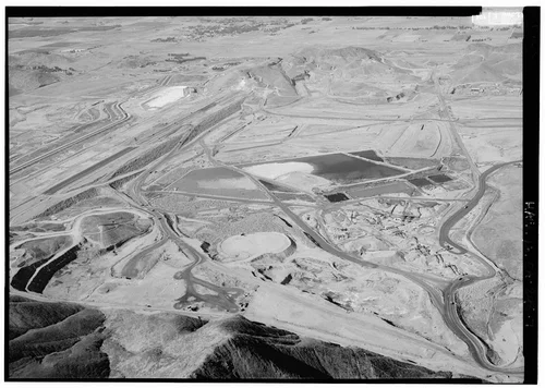  WEST DAM STRUCTURE, LOOKING NORTHWEST. QUARRIES AT BOTTOM; OUTLET STRUCTURE UNDER CONSTRUCTION CUTTING INTO HILL AT TOP OF PICTURE. - Eastside Reservoir, Diamond & Domenigoni Valleys, southwest of Hemet, Hemet, Riverside County, CA