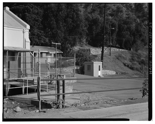  OVERVIEW OF SAR-3 AREA, SHOWING CORNER OF SAR-3 WITH TAILRACE, ADMINISTRATIVE OFFICE, TOILET SHED, AND RETAINING WALLS AT FORMER EMPLOYEE HOUSING SITE. VIEW TO SOUTHEAST. PANORAMA 1/2. - Santa Ana River Hydroelectric System, Redlands, San Bernardino County, CA