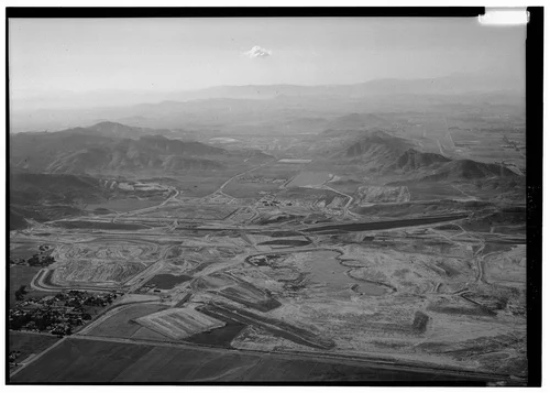  EASTSIDE RESERVOIR UNDER CONSTRUCTION LOOKING WEST WITH EAST DAM IN MIDDLE GROUND, WEST DAM IN DISTANCE. - Eastside Reservoir, Diamond & Domenigoni Valleys, southwest of Hemet, Hemet, Riverside County, CA
