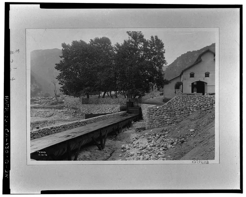  SAR-2, SHOWING TAILRACE REPAIRS AFTER FLOOD OF JANUARY, 1916; ALSO FLUME CONNECTION TO MENTONE SYSTEM.  SCE negative no. 3904, July 13, 1916.  Photograph by G. Haven Bishop. - Santa Ana River Hydroelectric System, SAR-2 Powerhouse, Redlands, San Bernardino County, CA