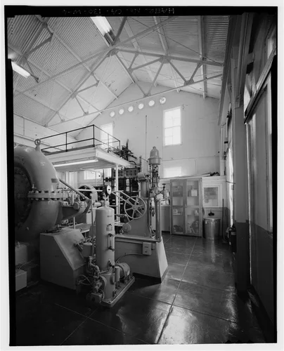  INTERIOR OVERVIEW WITH TURBINE WATERWHEEL GOVERNOR. PANORAMIC VIEW 1/2, LOOKING SOUTHEAST. - Santa Ana River Hydroelectric System, SAR-3 Powerhouse, Redlands, San Bernardino County, CA