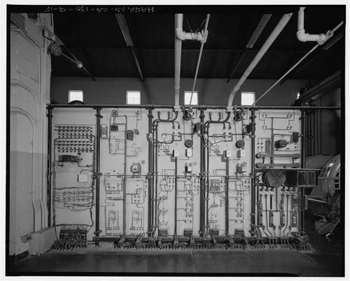  SAR-2, REAR OF DISCONNECT CONTROL PANEL, SHOWING CHAIN DRIVE RHEOSTAT LINKAGES.  VIEW TO EAST. - Santa Ana River Hydroelectric System, SAR-2 Powerhouse, Redlands, San Bernardino County, CA