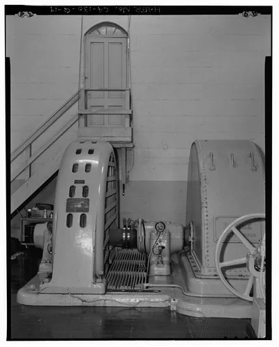  GENERATOR #2, NORTH EXIT WITH FANLIGHT, AND WATERWHEEL.  VIEW TO NORTH. - Santa Ana River Hydroelectric System, SAR-2 Powerhouse, Redlands, San Bernardino County, CA
