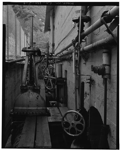  PENSTOCK RECEIVER AND ISOLATION VALVE, WITH #4 GENERATOR TURBINE SHUTOFF VALVE IN FOREGROUND. VIEW TO SOUTHEAST. - Santa Ana River Hydroelectric System, SAR-1 Powerhouse, Redlands, San Bernardino County, CA