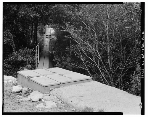  PLANK WALKWAY ATOP PIPE, ALSO SHOWING OVERFLOW CONTROL BOX AT JUNCTION OF PIPE WITH CONCRETE CHANNEL TO FISH SCREEN. VIEW TO NORTHEAST. - Santa Ana River Hydroelectric System, Pipeline to Fish Screen, Redlands, San Bernardino County, CA