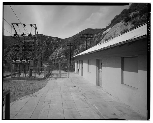  SOUTHWEST (FRONT) ELEVATION, WITH SAR-1 SWITCHRACK BEYOND.  VIEW TO NORTHWEST. - Santa Ana River Hydroelectric System, SAR-1 Machine Shop, Redlands, San Bernardino County, CA