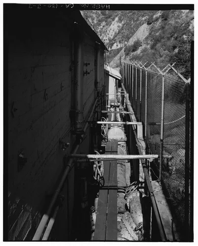  SOUTHEAST PENSTOCK ENTERING RECEIVER ON NORTHEAST SIDE OF SAR-1, ALSO SHOWING TURBINE SHUT OFF VALVES AND ISOLATION VALVE. VIEW TO WEST. - Santa Ana River Hydroelectric System, SAR-1 Powerhouse, Redlands, San Bernardino County, CA
