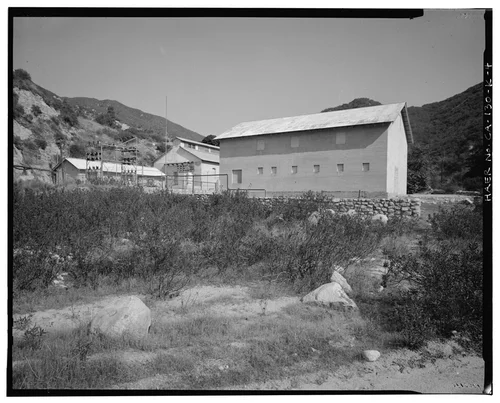  NORTHWEST ELEVATION, WITH CORRAL WALL AND SAR-1 IN THE DISTANCE. VIEW TO EAST. - Santa Ana River Hydroelectric System, SAR-1 Stable, Redlands, San Bernardino County, CA