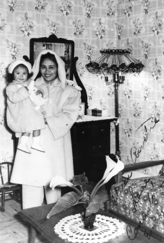 Filipino American woman holding child