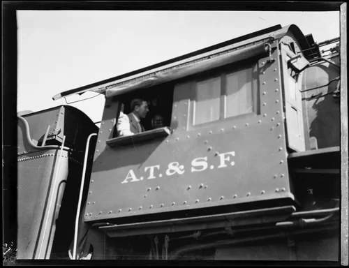 Crown Prince Gustav Adolf of Sweden in the cab, or engineer's compartment, of a train, [Los Angeles?], 1926