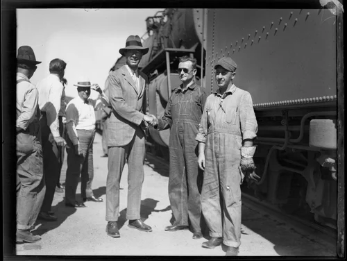 Crown Prince Gustav Adolf of Sweden shaking the hand of the engineer of his train, [Los Angeles?], 1926
