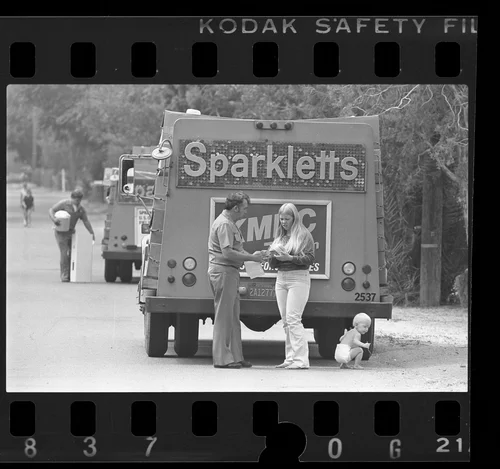 Sparkletts water delivery man signing up resident for free bottle water in Glen Avon in Riverside County, Calif., 1984