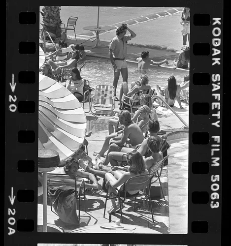 People mingling around pool during Spring Break in Palm Springs, Calif., 1980