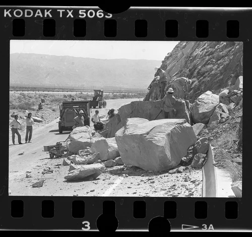 Caltrans crew at work on boulders blocking California 111, Palms Springs (vicinity), 1986