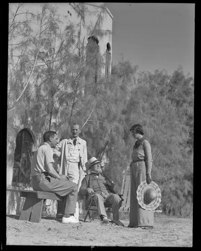 John McEnery, Gordon Coutts, Sir John Lavery and Mrs. John McEnery relax outside Coutt's home, Dar Marroc, Palm Springs, 1936