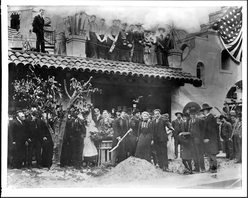 Portrait of Theodore Roosevelt planting an orange tree in front of the Mission Inn, Riverside, 1903