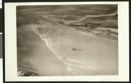 Aerial view of flooding of the Santa Ana River, showing breaks in levees near Santa Ana, ca.1930