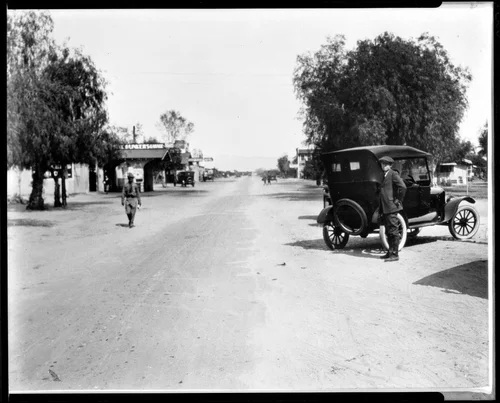 View of Main Street looking south in Palm Springs, showing early automobile, ca.1915
