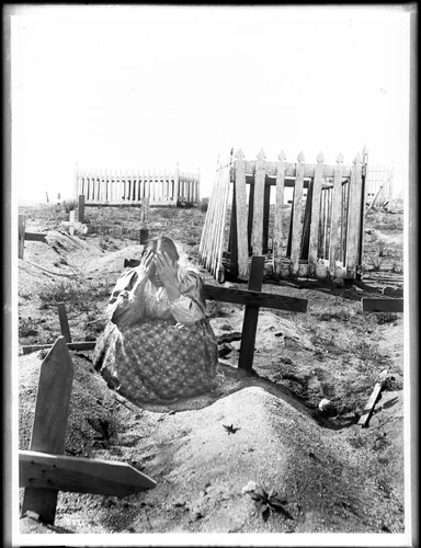 Ramona kneeling at the grave of Alesandro in the cemetery on the Coahuilla Indian Reservation, ca.1905