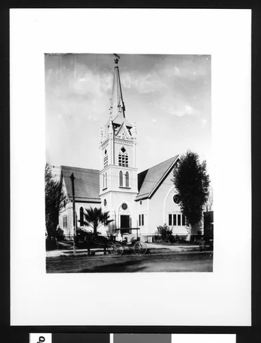 Exterior view of the San Bernardino Congregational Church, showing a horse-drawn carriage in front, ca.1903