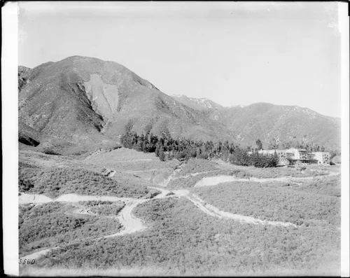 An angled view of Hot Springs Hotel, The Arrowhead, and a web of trails at Lake Arrowhead, 1915