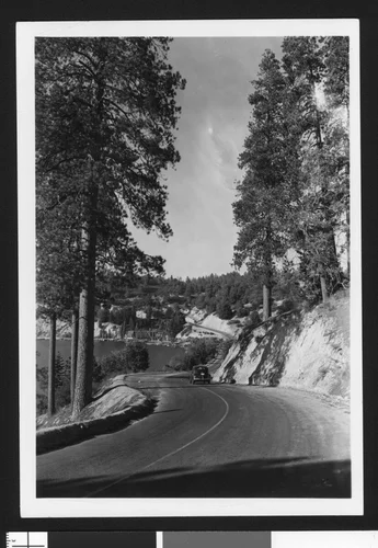 Automobile on a road bordering Lake Arrowhead, ca.1950