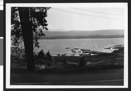 Big Bear Lake, showing a dock with boats at the near shore, ca.1950