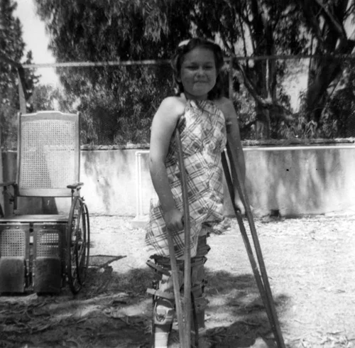 Girl with crutches at Casa Colina