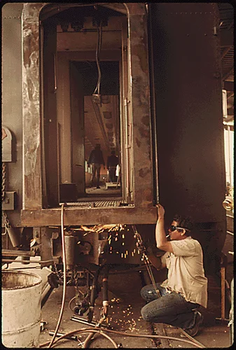 OLD PASSENGER CARS PURCHASED BY AMTRAK FROM SEVERAL OF THE NATION'S RAILROADS ARE RECONDITIONED AT A PLANT AT MIRA LOMA CALIFORNIA, NEAR RIVERSIDE. ALL MECHANICAL PARTS ARE OVERHAULED THE INTERIORS AND EXTERIORS ARE REPAINTED, AND THE INTERIORS ARE CARPETED AND REFURBISHED