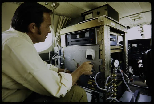 DR. JAMES N. PITTS, DIRECTOR OF AIR POLLUTION RESEARCH CENTER WITH MONITORING EQUIPMENT INSIDE NASA PLANE