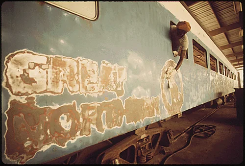 AMTRAK PASSENGER CARS ARE RENOVATED AT A PLANT IN MIRA LOMA, CALIFORNIA, NEAR RIVERSIDE. IT IS ONE OF SEVERAL PLACES WHERE EQUIPMENT OBTAINED FROM THE NATION'S RAILROADS IS OVERHAULED MECHANICALLY. THIS CAR CAME FROM THE GREAT NORTHERN RAILWAY, PART OF BURLINGTON NORTHERN. IT WILL BE REPAINTED INSIDE AND OUT AND RECONDITIONED ON THE INTERIOR