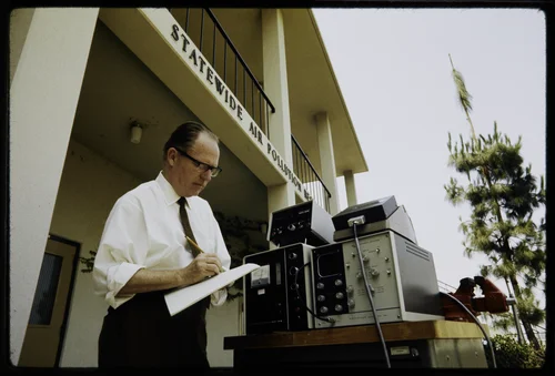 EDGAR STEPHENS, PROFESSOR OF ENVIRONMENTAL SCIENCE AT THE STATE-WIDE AIR POLLUTION RESEARCH CENTER, USING OPTICAL PARTICLE COUNTER