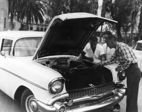American Indian students and instructor with car