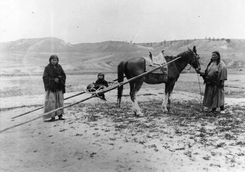 American Indian women and child in travois