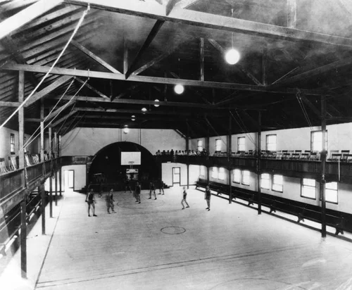 Basketball players in Sherman Institute gymnasium